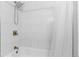 Tiled shower with a detachable head and rainfall fixture and a white shower curtain at 8979 Field St # 27, Westminster, CO 80021
