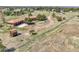 Expansive aerial view of a secluded home with mature trees, a long driveway, and outbuildings on acreage at 811 Panorama Dr, Elizabeth, CO 80107
