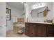 Well-lit bathroom featuring a tiled bathtub, vanity with a sink, and modern fixtures at 811 Panorama Dr, Elizabeth, CO 80107