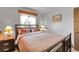 Comfortable bedroom with window and bedside lamps, creating a warm and inviting space at 811 Panorama Dr, Elizabeth, CO 80107
