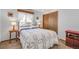 Bright bedroom with a decorative quilt, complemented by natural light from the window at 811 Panorama Dr, Elizabeth, CO 80107