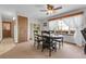 Traditional dining room with a wooden table, chairs, and natural light from the window at 811 Panorama Dr, Elizabeth, CO 80107