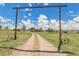 Inviting gravel driveway framed by a decorative entrance, leading to a secluded home on a sprawling property at 811 Panorama Dr, Elizabeth, CO 80107