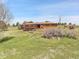 Sprawling ranch home with a large yard and an outbuilding on a sunny day at 811 Panorama Dr, Elizabeth, CO 80107