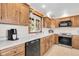 Well-lit kitchen featuring updated appliances, white countertops, wooden cabinets, and a view of the sink window at 811 Panorama Dr, Elizabeth, CO 80107