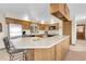 Spacious kitchen with wooden cabinetry, stainless steel appliances, and a large island with seating at 811 Panorama Dr, Elizabeth, CO 80107
