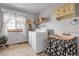 Functional laundry room featuring a washing machine, sink, and natural light at 811 Panorama Dr, Elizabeth, CO 80107