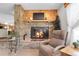 Inviting living room with a stone fireplace, wood accents, and comfortable seating at 811 Panorama Dr, Elizabeth, CO 80107