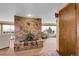 Cozy living room with a stone fireplace, bright windows, and comfortable seating, creating an inviting space at 811 Panorama Dr, Elizabeth, CO 80107