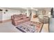 Spacious living room featuring a comfortable recliner sofa and colorful area rug at 811 Panorama Dr, Elizabeth, CO 80107