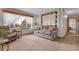 Cozy living room featuring neutral tones, a comfortable sofa, and a large window with natural light at 811 Panorama Dr, Elizabeth, CO 80107