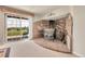The living room features a stone fireplace and a sliding glass door that provides outside access at 811 Panorama Dr, Elizabeth, CO 80107