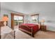 Bright main bedroom featuring a private balcony with scenic views, enhancing the relaxing atmosphere at 811 Panorama Dr, Elizabeth, CO 80107