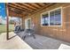 Covered outdoor patio with wood ceiling and furniture, perfect for relaxing and entertaining at 811 Panorama Dr, Elizabeth, CO 80107