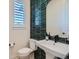 Stylish powder room featuring dark green tile, modern fixtures, and a sleek design at 805 Promenade Dr, Superior, CO 80027