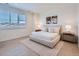 Serene bedroom with a plush bed, neutral decor, and ample natural light from a large window at 805 Promenade Dr, Superior, CO 80027