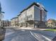 Modern townhomes featuring stone accents, balconies and attached garages along a well-maintained street at 805 Promenade Dr, Superior, CO 80027