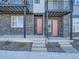 Close-up of townhome entrances featuring stone accents, private entrances, and small garden at 805 Promenade Dr, Superior, CO 80027
