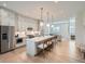 Modern kitchen showcases a large island, light gray cabinetry, and an open-concept design at 805 Promenade Dr, Superior, CO 80027