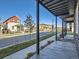 Street view from a covered porch, showcasing a modern neighborhood with mountain views at 805 Promenade Dr, Superior, CO 80027