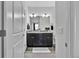 Bathroom featuring double sinks with granite countertop and ceramic tile flooring at 4569 Copeland Loop # 203, Highlands Ranch, CO 80126