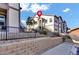 Apartment building with well-maintained landscaping, secured by a black metal fence and rock bed at 4569 Copeland Loop # 203, Highlands Ranch, CO 80126