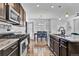 Modern kitchen featuring stainless appliances, granite counters, and dark cabinetry with an adjacent eat-in dining space at 4569 Copeland Loop # 203, Highlands Ranch, CO 80126
