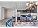 Stylish kitchen with dark cabinetry, granite counters, stainless appliances, eat-in counter, adjacent dining area at 4569 Copeland Loop # 203, Highlands Ranch, CO 80126