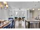 Open concept: kitchen view to the bright living room with two windows and stylish green chairs at 4569 Copeland Loop # 203, Highlands Ranch, CO 80126