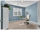 Bright office featuring blue walls, a white desk, shelving, and a large window for natural light at 4569 Copeland Loop # 203, Highlands Ranch, CO 80126