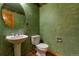 Cozy bathroom with pedestal sink and natural wood flooring at 5571 S Sicily St, Aurora, CO 80015