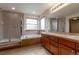 Bathroom featuring a soaking tub, shower, and double vanity at 5571 S Sicily St, Aurora, CO 80015