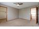 Neutral bedroom with ceiling fan, carpet, and natural wood trim, creating a calm, inviting space at 5571 S Sicily St, Aurora, CO 80015