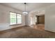 Inviting dining room with natural light and modern light fixture at 5571 S Sicily St, Aurora, CO 80015