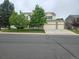 Beautiful home featuring a three-car garage, well-maintained lawn, and mature trees at 5571 S Sicily St, Aurora, CO 80015