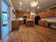 Spacious kitchen featuring wooden cabinets, a central island, and modern appliances at 5571 S Sicily St, Aurora, CO 80015