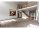 Bright living room with hardwood floors, staircase, and view into the kitchen, perfect for entertaining at 5571 S Sicily St, Aurora, CO 80015