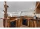 Detailed custom wooden bar with a sink, mini-fridge, and a dishwasher at 4320 Snowbird Ave, Broomfield, CO 80020