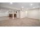 Spacious basement area with a rustic bar setup, carpeted area, and neutral decor at 4320 Snowbird Ave, Broomfield, CO 80020