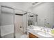 A modern bathroom with glass doors, a built in bench, and updated fixtures at 4320 Snowbird Ave, Broomfield, CO 80020