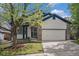 Charming two-story home with a brick and siding facade, a well-manicured lawn, and an attached two-car garage at 4320 Snowbird Ave, Broomfield, CO 80020