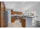 Well-lit kitchen featuring stainless steel appliances, tiled floors, and updated countertops at 4320 Snowbird Ave, Broomfield, CO 80020