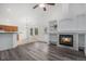 Open-concept living and dining area featuring a fireplace and modern floors at 4320 Snowbird Ave, Broomfield, CO 80020