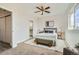 This bedroom features a ceiling fan, area rug and en-suite bathroom at 12032 Monaco St, Brighton, CO 80602