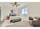 Inviting bedroom with neutral tones, carpet, area rug, ceiling fan and natural light at 12032 Monaco St, Brighton, CO 80602