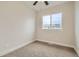 Carpeted bedroom with a ceiling fan and view to the community at 12032 Monaco St, Brighton, CO 80602