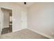 Neutral bedroom with neutral carpeting and white door at 12032 Monaco St, Brighton, CO 80602