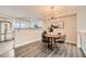 Open-concept dining area with modern lighting and views into the kitchen, perfect for entertaining guests at 12032 Monaco St, Brighton, CO 80602