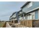 Exterior shot of blue townhomes with wood fences and rock features at 12032 Monaco St, Brighton, CO 80602