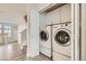 Laundry room featuring modern washer and dryer with white cabinets above at 12032 Monaco St, Brighton, CO 80602